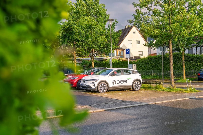 An electric car parked in the sunset on a quiet street surrounded by trees, Deer E, car sharing, electric car, Calw, Black Forest