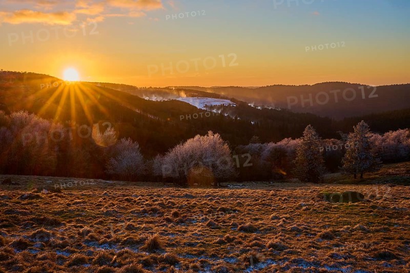 Sunset over snowy hills with a warm orange light, winter, Route de Cretes, Hohneck, La Bresse, Vosges, France