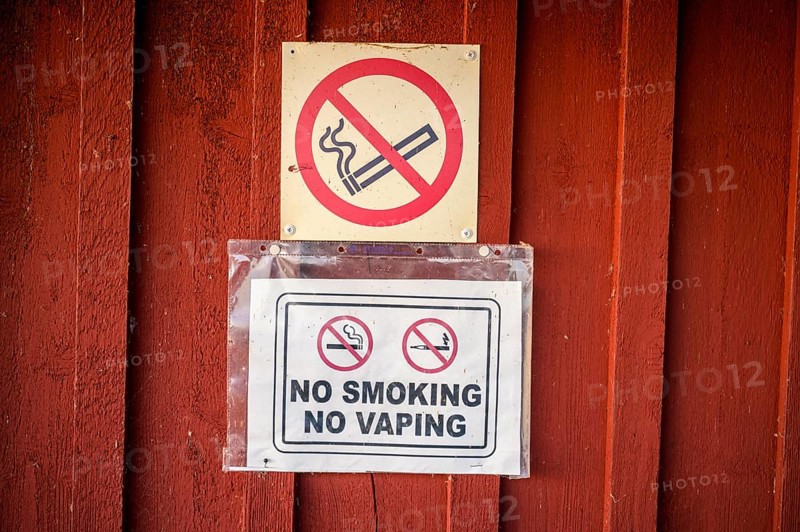 Red wall with no smoking signs prohibiting smoking and vaping, Svedjehamn, Kvarken Archipelago, Finland