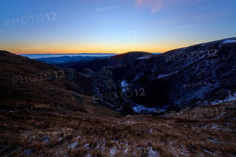 First rays of light over mountain peaks, cool morning with purple sky, view of the Rhine Valley, Martinswand, Frankental, Vosges, France