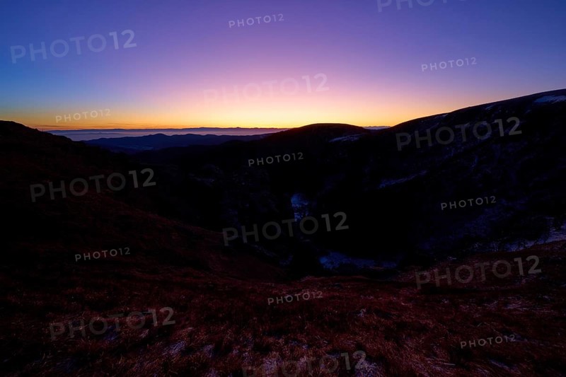 Sunrise over dark mountains with purple sky at dusk, looking towards the Rhine Valley, Martinswand, Frankental, Vosges, France