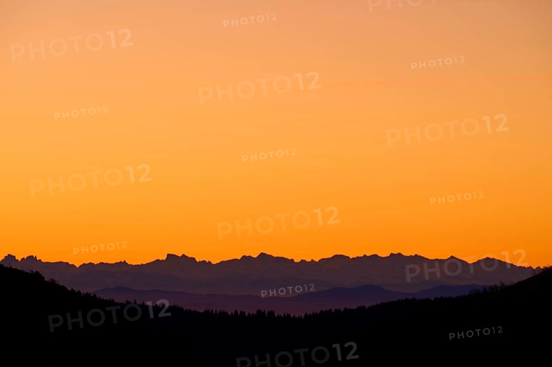 Mountain silhouette at sunrise with orange sky, looking at Alps, Hohneck, La Bresse, Vosges, France