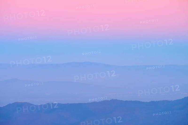 Rolling hills under a pink and blue sky at sunset, looking towards the Rhine Valley, Hohneck, La Bresse, Vosges, France
