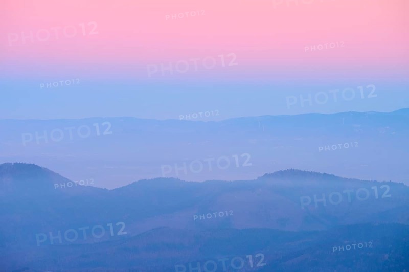 Foggy mountains spreading out under a pink sky, sunset, looking towards the Rhine Valley, Hohneck, La Bresse, Vosges, France