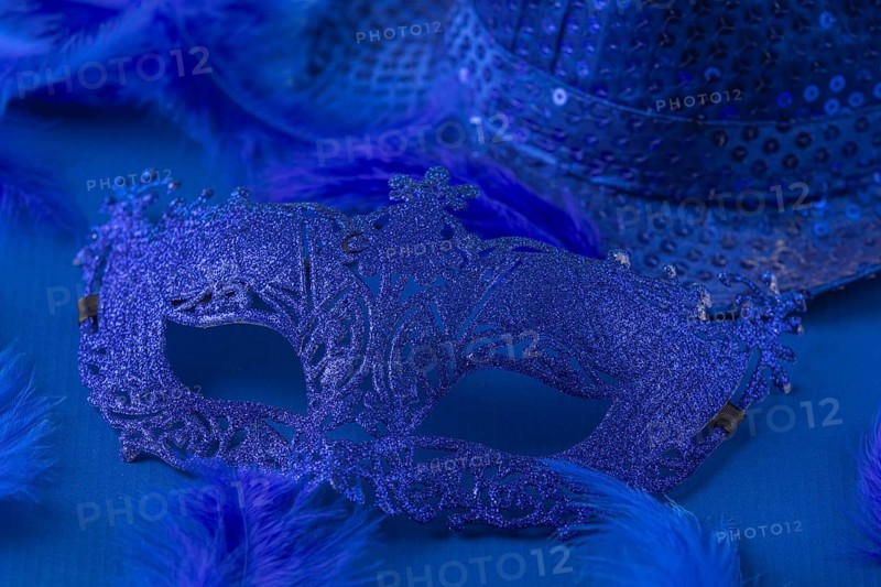 Blue mask with matching feathers and hat on blue background, carnival