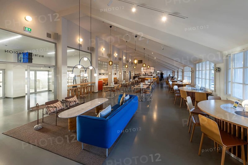 A 1950s style restaurant with seating, tables, large windows and hanging lamps, Olympic Stadium, architects Yrjö Lindegren and Toivo Jäntti, Helsinki, Finland