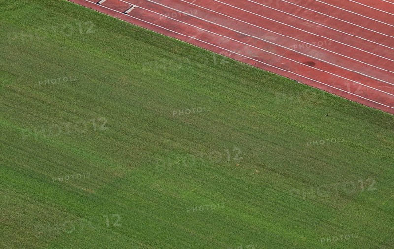 View of well-maintained stadium lawn and tartan track from the Olympic Stadium tower, Helsinki, Finland