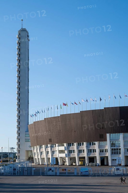 Tower with external staircase, Olympic Stadium with flags on the roof, architects Yrjö Lindegren and Toivo Jäntti, Helsinki, Finland