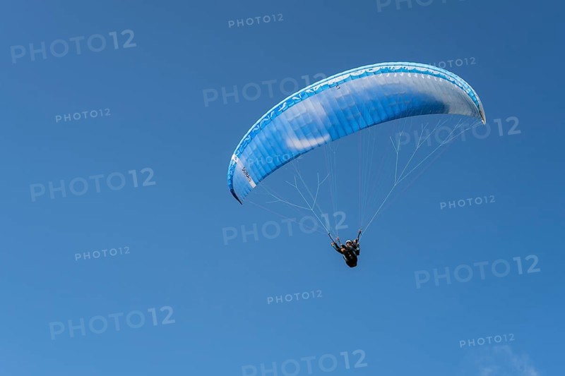 Single paraglider in the blue sky symbolizing freedom and adventure, paraglider near Gudauri, Mtskheta-Mtianeti region, Georgian Military Highway, High Caucasus, Georgia