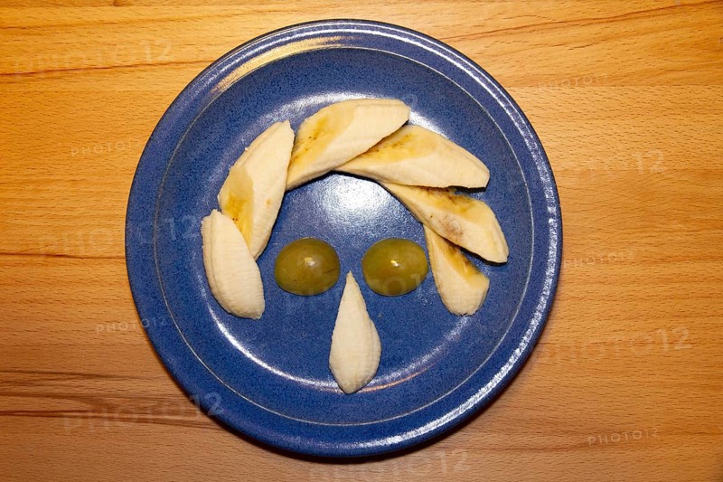 Fruit plate as a face, humor, banana, grapes