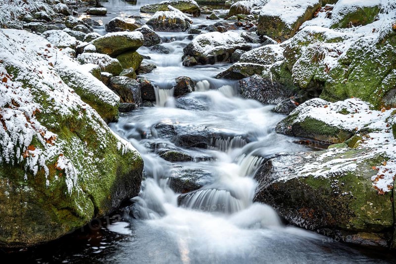 Lower Ilse Falls with snow and moss covered rocks in winter, Heinrich-Heine-Weg, Ilsetal, Harz National Park, Saxony-Anhalt, Germany