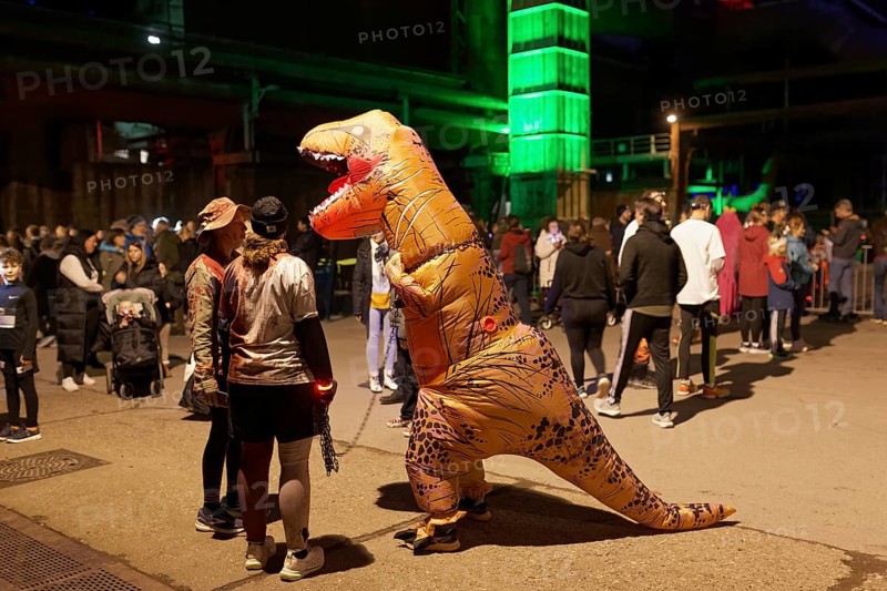 Person in inflatable dinosaur costume at Halloween Run, night run in the Duisburg-Nord Landscape Park, Duisburg, Germany, North Rhine-Westphalia, Germany