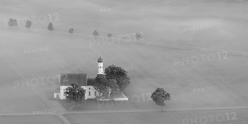 St. Coloman pilgrimage church in front of sunrise in autumn fog, Königswinkel, Ostallgäu, Allgäu, Bavaria, Germany