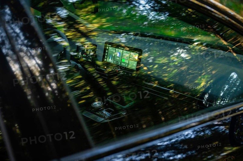 Modern car interior with screens, reflecting forest light and green ambiance, MG4 electric car, Deer e-Carsharing, Calw, Germany