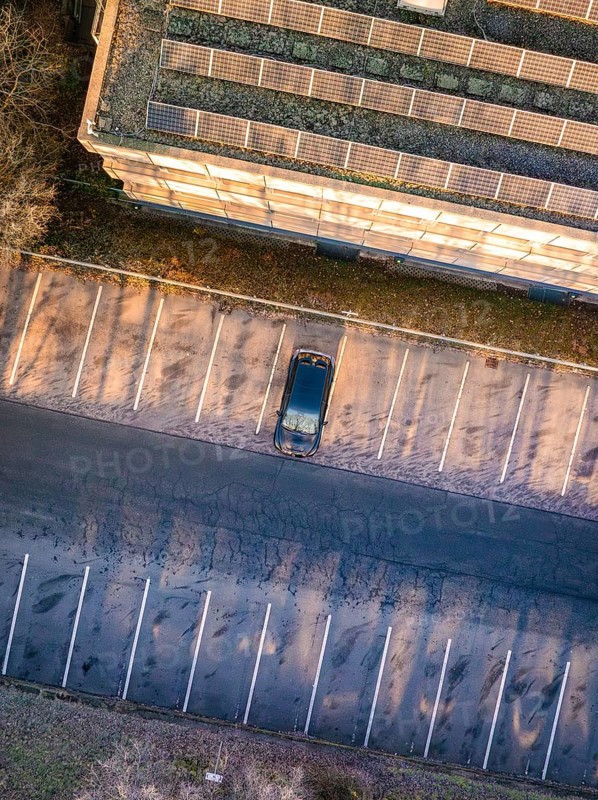 Aerial view of an empty parking lot with a single car next to a building, MG4 electric car, Deer e-Carsharing, Calw, Germany