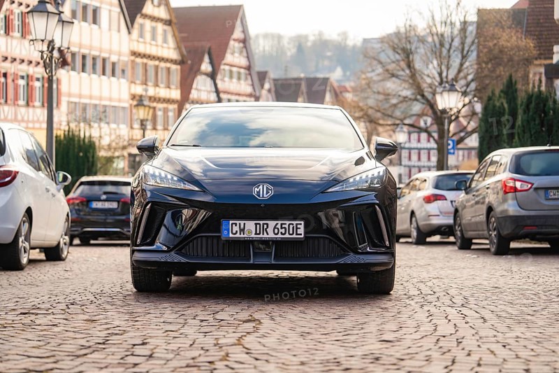 A car in an old town street with half-timbered houses and cobblestones, MG4 electric car, Deer e-Carsharing, Calw, Germany
