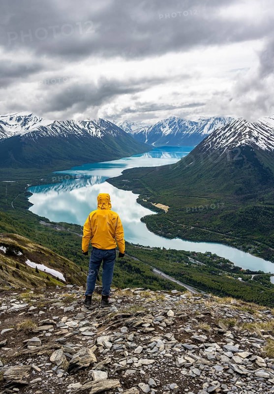 Climber enjoying the view, Slaughter Ridge Trail, view of snowy mountains and turquoise blue Kenai Lake, Cooper Landing, Kenai Peninsula, Alaska, USA