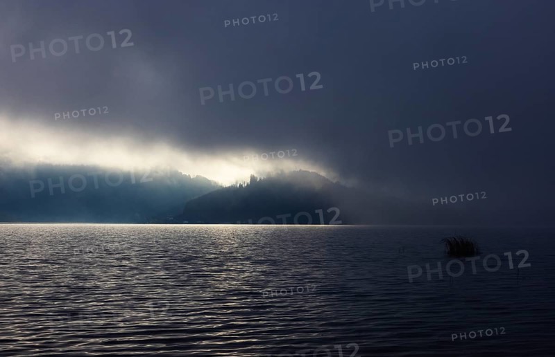 Foggy morning atmosphere with sunrise at the lake, Mondsee, Salzkammergut, Upper Austria, Austria