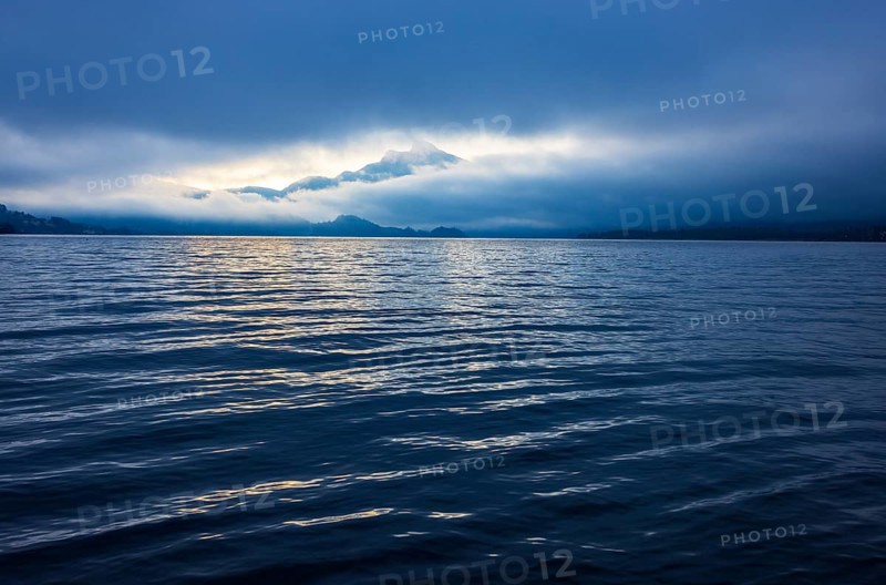 Misty morning atmosphere at the lake with Schafberg, Mondsee, Salzkammergut, Upper Austria, Austria
