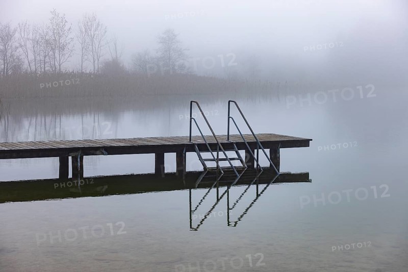 Foggy autumn atmosphere at the lake with wooden footbridge, Irrsee, Salzkammergut, Upper Austria, Austria