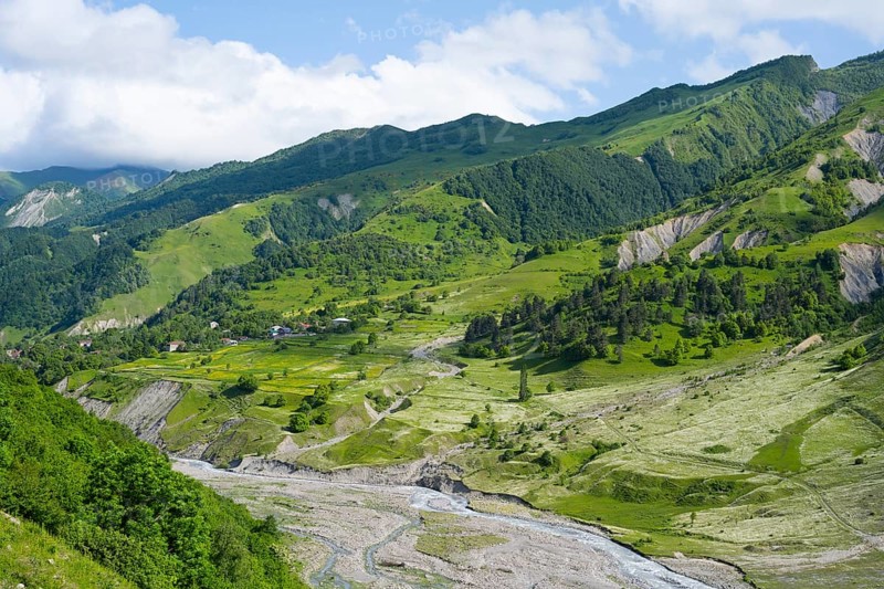 Wide green hills and a river criss-cross the mountainous landscape, landscape between Kvesheti and Gudauri, White Aragvi River, Mtskheta-Mtianeti region, Georgian Military Highway, High Caucasus, Georgia
