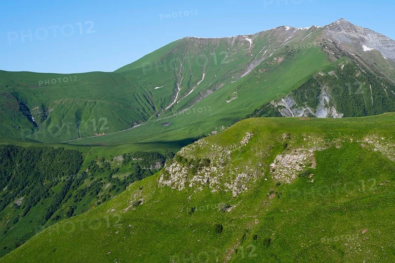 Green mountainside under clear sky, natural peace, landscape between Kvesheti and Gudauri, Mtskheta-Mtianeti region, Georgian Military Road, High Caucasus, Georgia