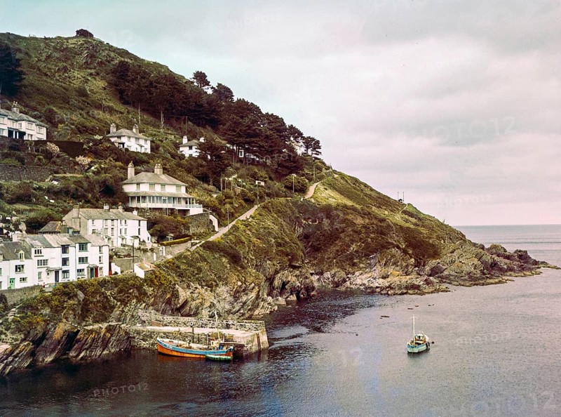 Historic waterfront buildings around the harbour river mouth of the River Pol at village of Polperro, Cornwall, England, UK