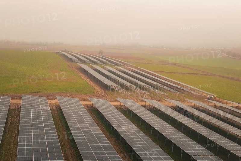Rows of solar panels on vast green fields, focus on sustainability, energy transition, construction of PV open space, Baden-Württemberg, Germany