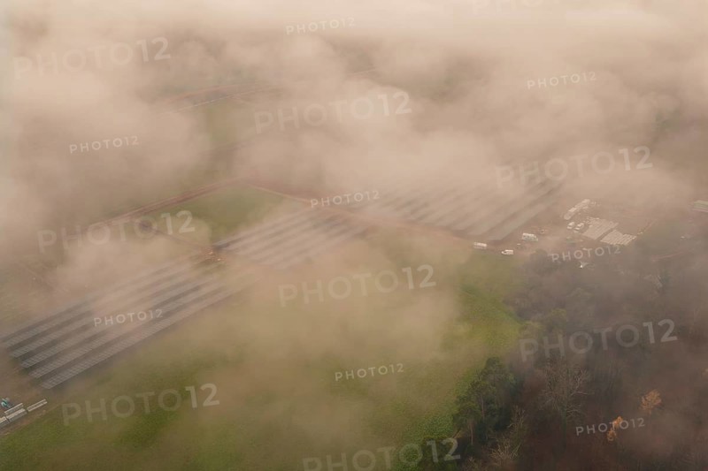 Solar systems in a foggy field landscape, diffuse view through thick fog, energy revolution, construction of PV open space, Baden-Württemberg, Germany