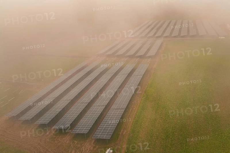 Rows of solar panels spread over foggy field, focus on renewable energy, energy transition, construction of PV open space, Baden-Württemberg, Germany