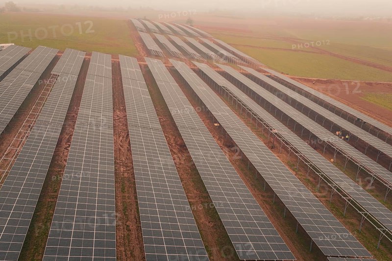 Extensive solar panel layout in foggy landscape, sustainable energy source, energy transition, construction of PV open space, Baden-Württemberg, Germany