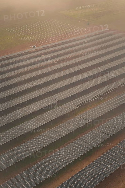 Arranged rows of solar panels on field, foggy atmosphere with structured pattern, energy transition, construction of PV open space, Baden-Württemberg, Germany