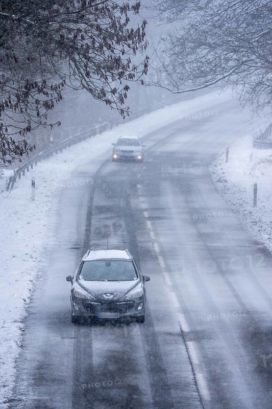 Country road in Elfringhauser Switzerland, near Sprockhövel, cars with and without headlights, lights on, snowfall, snowy, North Rhine-Westphalia, Germany