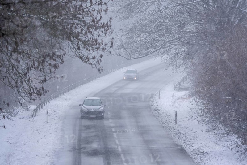 Country road in Elfringhauser Switzerland, near Sprockhövel, cars with and without headlights, lights on, snowfall, snowy, North Rhine-Westphalia, Germany