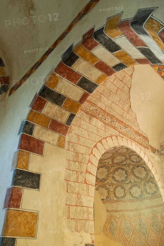Painted arch in red, yellow and black. St Aignan's Church of Begues. Allier department. Auvergne Rhone Alpes. France. Europe