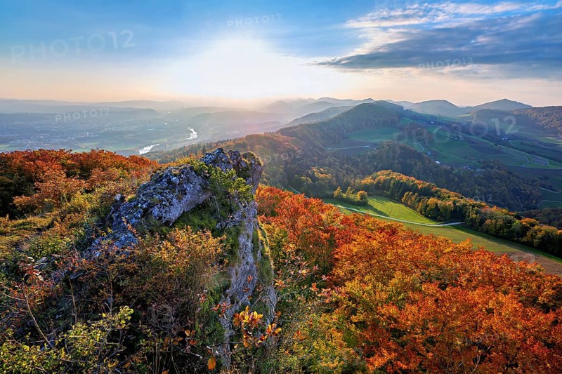 View from the Gisliflue of an autumn-colored forest, behind the Jurassic foothills with water fluh and stripes in the light of the setting sun, Talheim, Canton, Aargau, Swiss flag in the stern of the motor ship Brunnen in Fahr, Lake Lucerne, Brunnen, Canton of Schwyz, Switzerland