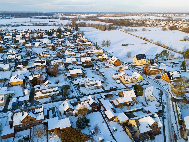 Aerial view of a snowy village landscape with houses and roads, aerial view, Oelsburg, Ilsede municipality, Peine district, Lower Saxony, Germany