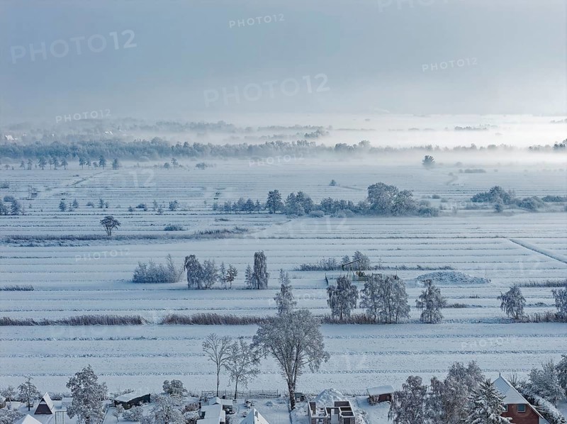 The onset of winter with snow and ground fog in Hamburg's Kirchwerder Wiesen Nature Reserve in the Vier- and Marschlanden. aerial view. Kirchwerder, Hamburg, Germany