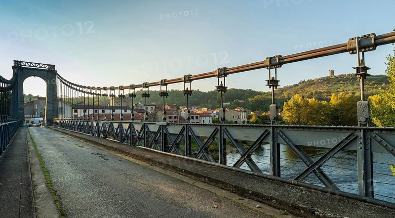 Suspension bridge of Coudes village on river Allier. Puy de Dome. Auvergne Rhone Alpes. France