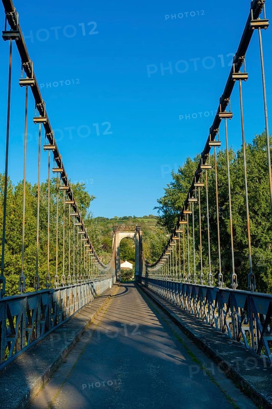 Suspension bridge of Coudes village on river Allier. Puy de Dome. Auvergne Rhone Alpes. France