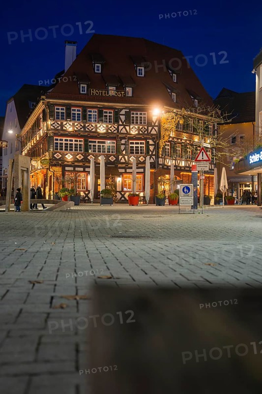 Traditional half-timbered hotel at night with lighting on an urban square, Nagold, Calw district, Black Forest, Germany