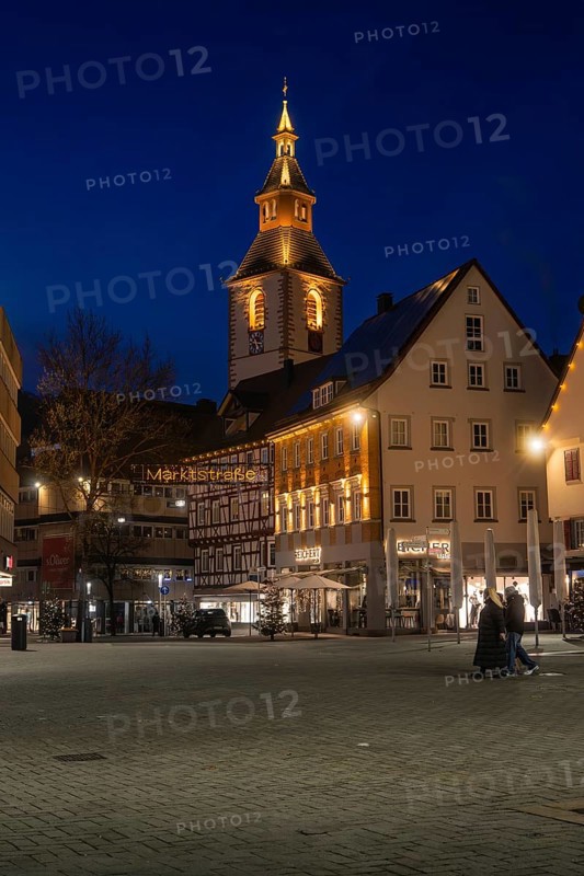 Church tower and half-timbered houses stylishly illuminated at night on a town square, Nagold, Calw district, Black Forest, Germany