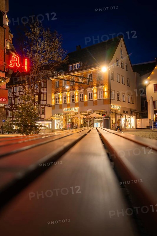 Night scene with illuminated shops and Christmas decorations in a shopping street, Nagold, Calw district, Black Forest, Germany