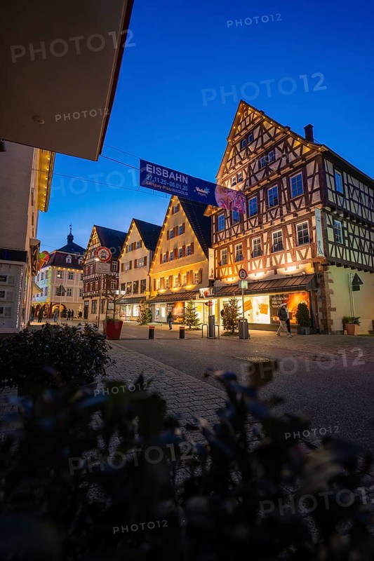 Illuminated houses with traditional architecture and ice banners at night, Nagold, Calw district, Black Forest, Germany
