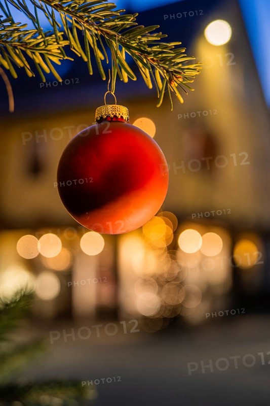 Red Christmas ball on pine branch, blurred background with lights, Nagold, Calw district, Black Forest, Germany