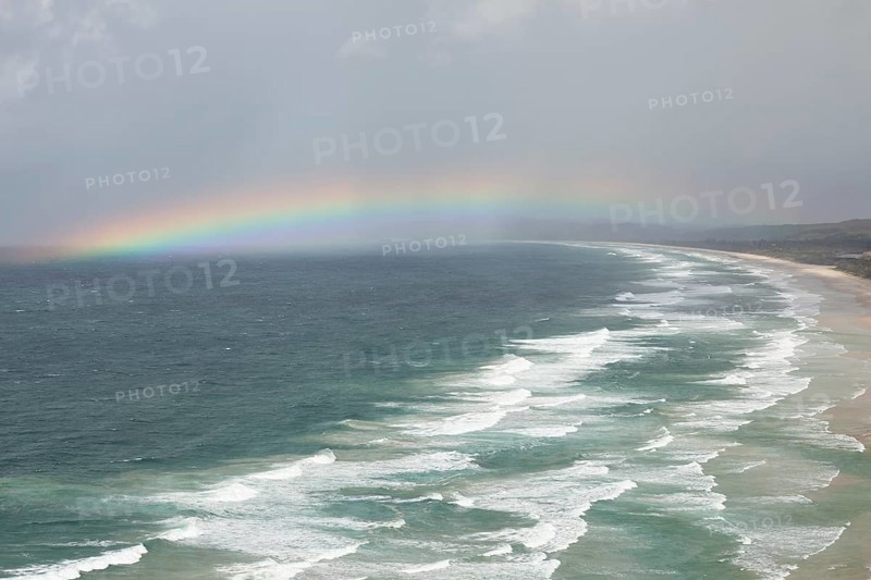 Tallow Beach bay with rainbow, lookout Byron Bay lighthouse, New South Wales, Australia