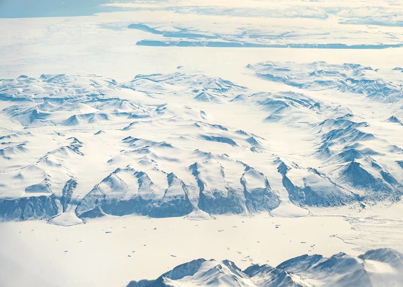 Glacier tongues flow into huge glaciers, snowy arctic mountain landscape, aerial view, Greenland, Arctic