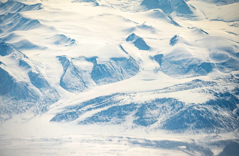 Glacier tongues flow into glaciers, snowy arctic mountain landscape, aerial view, Greenland, Arctic