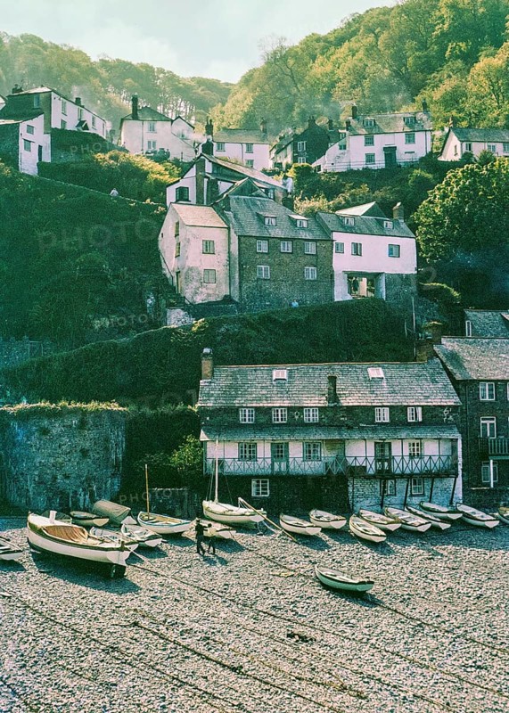 Historic buildings in harbour boats on beach at Clovelly, north Devon, England, UK 1960s