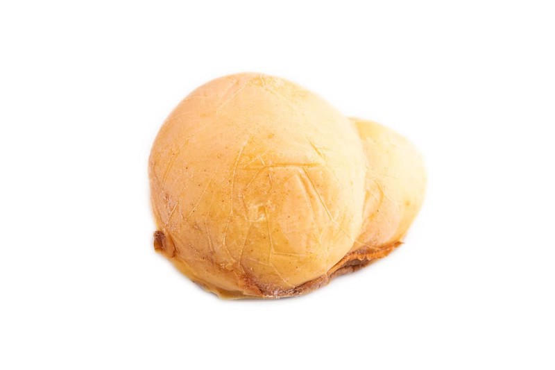 Smoked Mozzarella cheese, with tomatoes and olives isolated on white background, side view, copy space